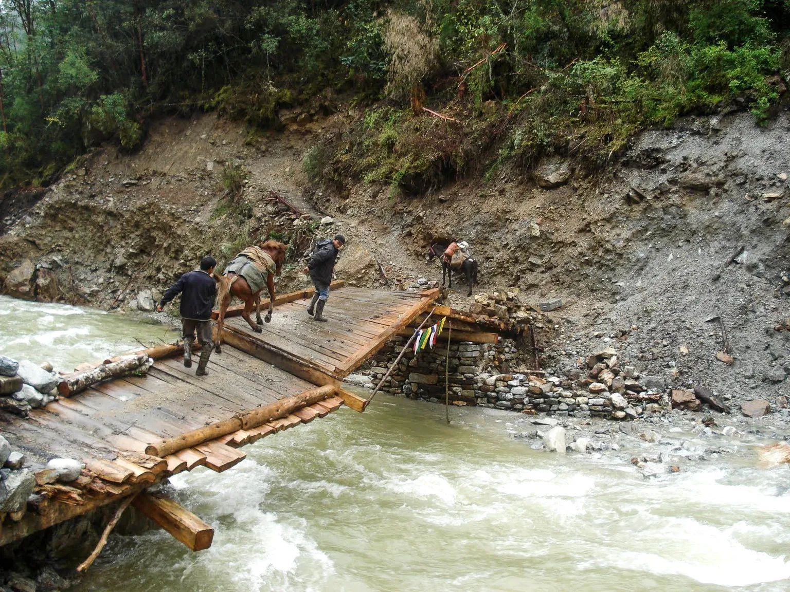 A man-made bridge at risk of collapse due to rising water levels