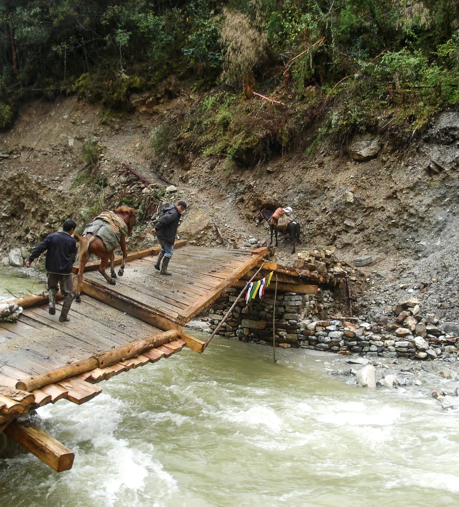 A man-made bridge at risk of collapse due to rising water levels