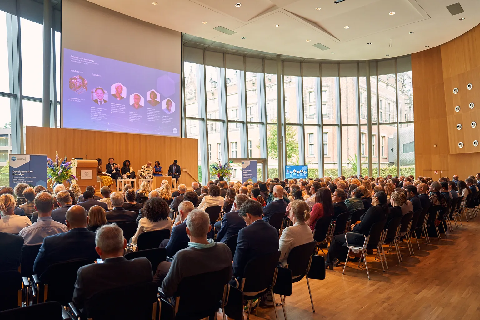 Attendees of the SNV60 event speaking to each other