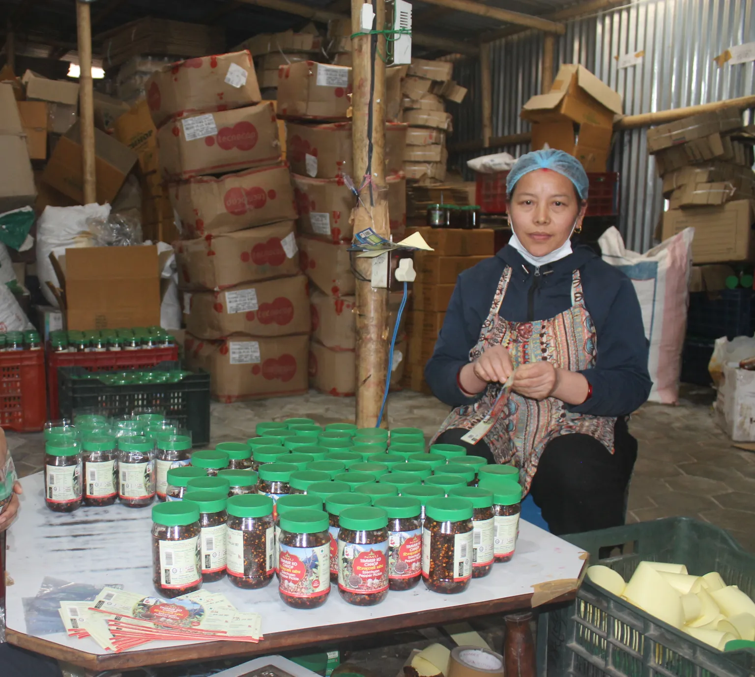 Bimala Tamang, an employee at Nepali pickling factory, packing pickles