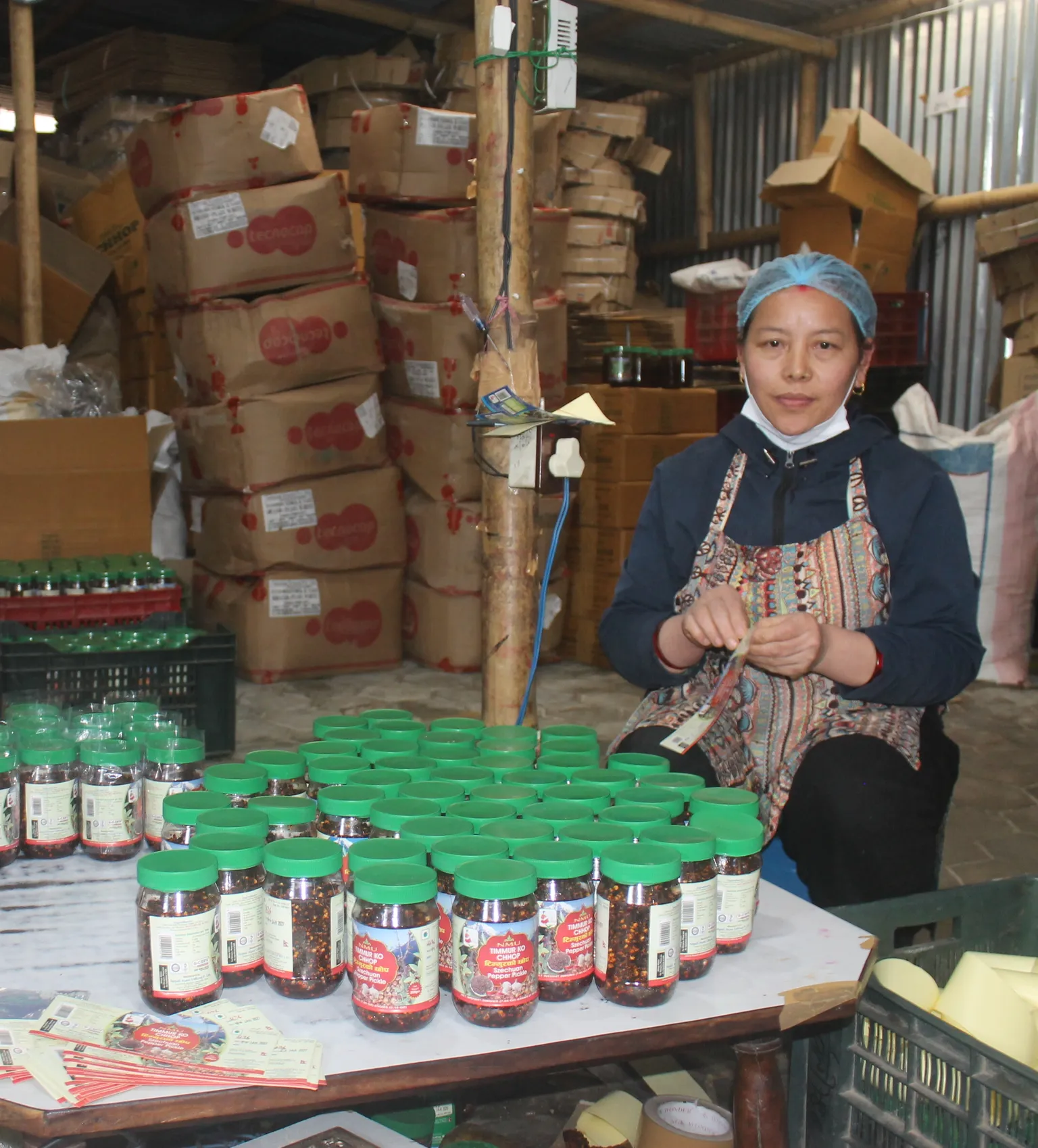 Bimala Tamang, an employee at Nepali pickling factory, packing pickles