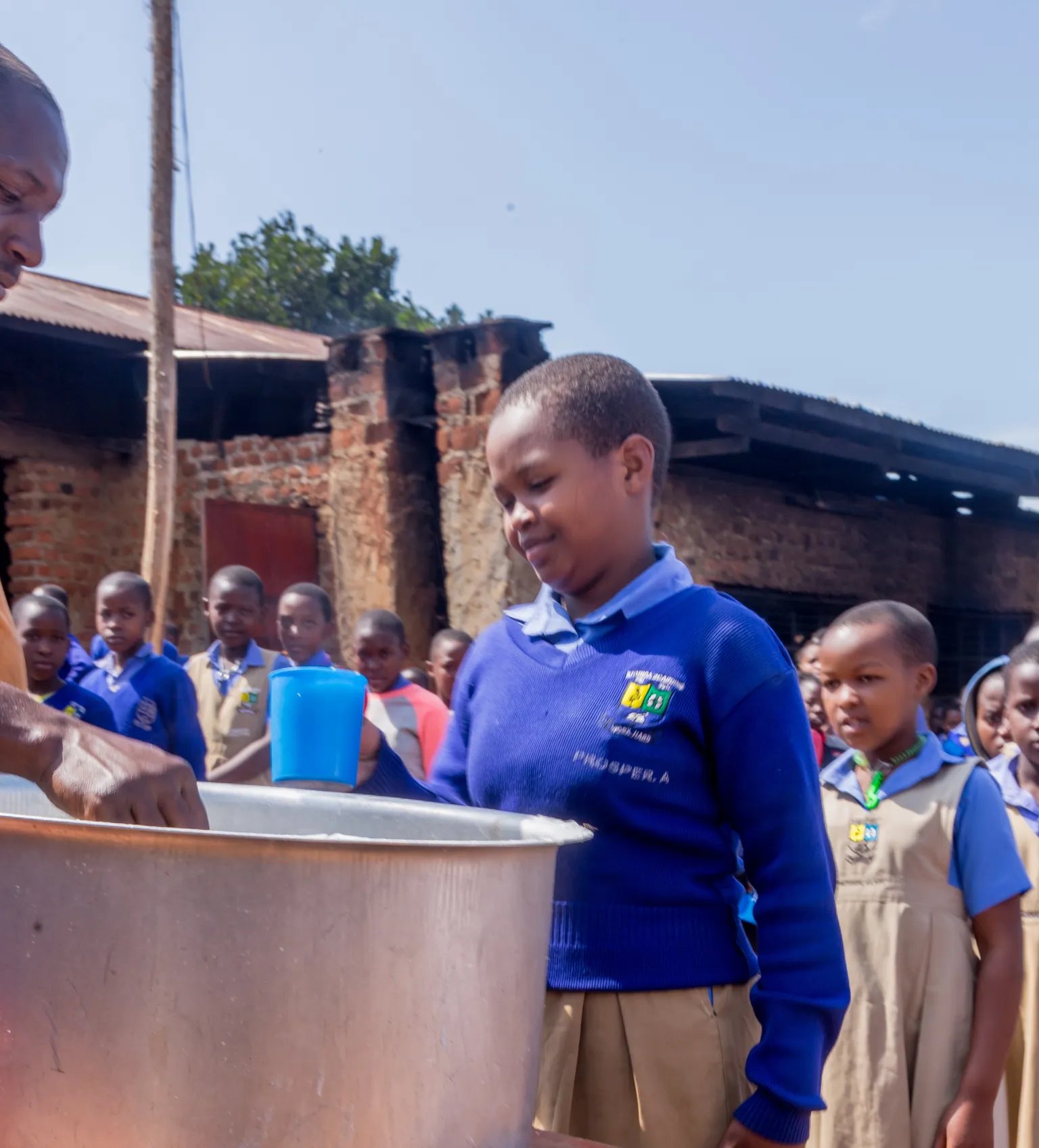 A group of children attend school in Uganda, accessing school meals with support from SNV's TIDE project.