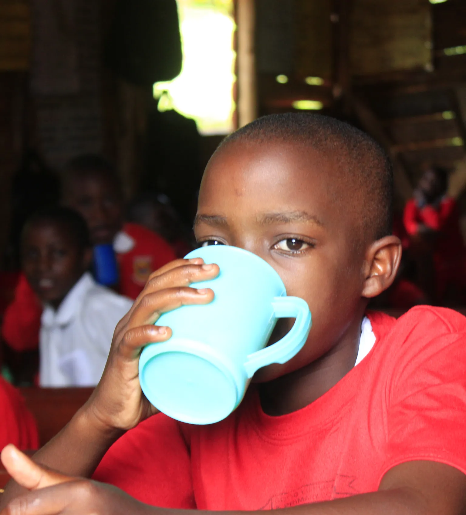 School feeding Uganda, children drinking milk