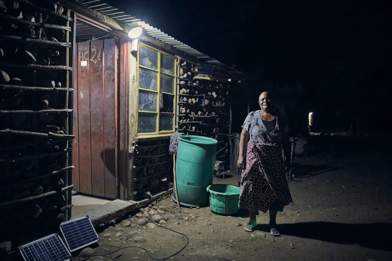 Woman standing outside her solar home 